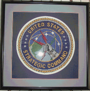 Stratcom Emblem stitched by Penny Staley using 3 strands floss on 14 count triple matted framed size 22 inches square